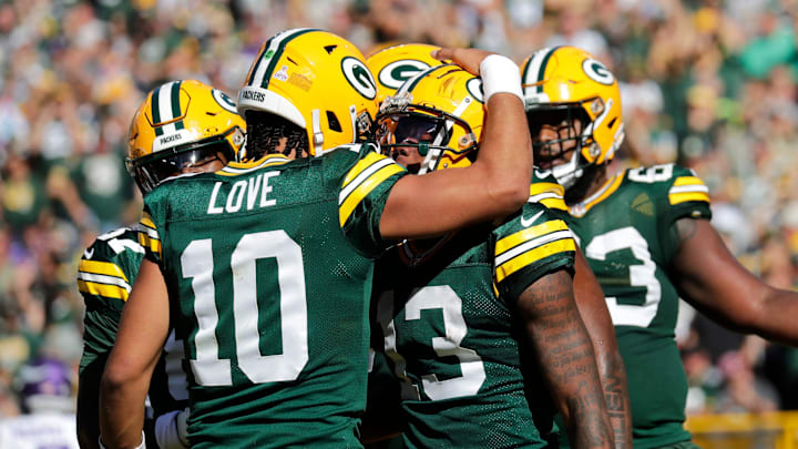Green Bay Packers quarterback Jordan Love (10) and Dontayvion Wicks (13) celebrate a touchdown reception against the Minnesota Vikings during their football game Sunday, September 29, 2024, at Lambeau Field in Green Bay, Wisconsin.