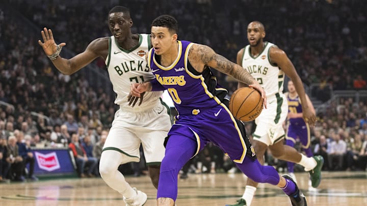 Mar 19, 2019; Milwaukee, WI, USA; Los Angeles Lakers forward Kyle Kuzma (0) drives for the basket against Milwaukee Bucks guard Tony Snell (21) during the first quarter at Fiserv Forum. Mandatory Credit: Jeff Hanisch-Imagn Images Mar 19, 2019; Milwaukee, WI, USA; Los Angeles Lakers forward Kyle Kuzma (0) drives for the basket against Milwaukee Bucks guard Tony Snell (21) during the first quarter at Fiserv Forum. Mandatory Credit: Jeff Hanisch-Imagn Images