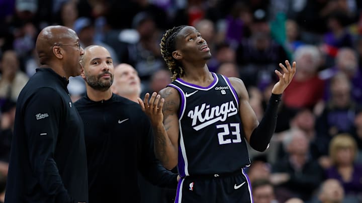 Mar 25, 2024; Sacramento, California, USA; Sacramento Kings guard Keon Ellis (23) reviews a call with head coach Mike Brown during the second quarter against the Philadelphia 76ers at Golden 1 Center. Mandatory Credit: Sergio Estrada-Imagn Images