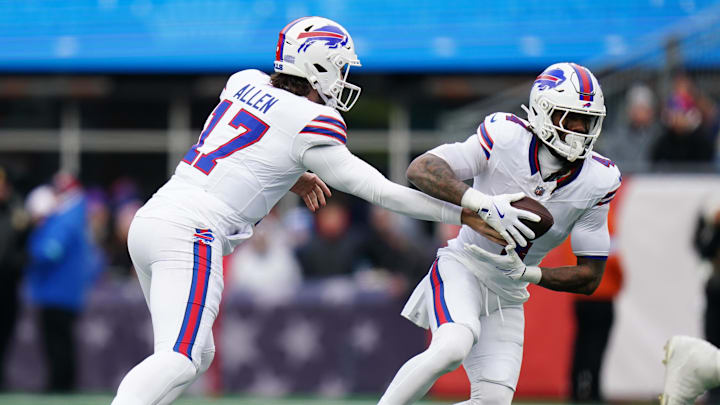 Jan 5, 2025; Foxborough, Massachusetts, USA; Buffalo Bills quarterback Josh Allen (17) hands off the ball to running back James Cook (4) against the New England Patriots in the first quarter at Gillette Stadium. Mandatory Credit: David Butler II-Imagn Images