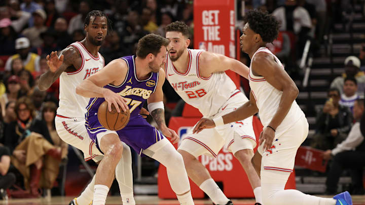 Mar 18, 2026; Houston, Texas, USA; Los Angeles Lakers guard Luka Doncic (77) dribbles against Houston Rockets center Alperen Sengun (28) and the Rockets defense in the first quarter at Toyota Center. Mandatory Credit: Thomas Shea-Imagn Images Mar 18, 2026; Houston, Texas, USA; Los Angeles Lakers guard Luka Doncic (77) dribbles against Houston Rockets center Alperen Sengun (28) and the Rockets defense in the first quarter at Toyota Center. Mandatory Credit: Thomas Shea-Imagn Images