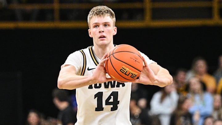 Nov 20, 2025; Iowa City, Iowa, USA; Iowa Hawkeyes guard Bennett Stirtz (14) passes the ball against the Chicago State Cougars during the second half at Carver-Hawkeye Arena. Mandatory Credit: Jeffrey Becker-Imagn Images