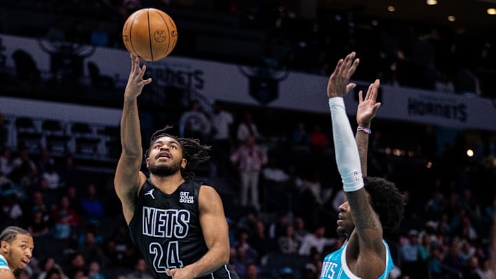Mar 8, 2025; Charlotte, North Carolina, USA; Brooklyn Nets guard Cam Thomas (24) shoots on Charlotte Hornets guard Damion Baugh (7) during the first quarter at Spectrum Center. Mandatory Credit: Scott Kinser-Imagn Images