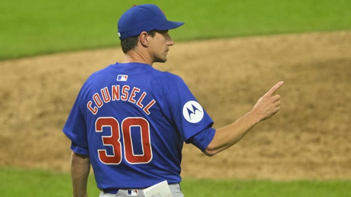 Aug 12, 2024; Cleveland, Ohio, USA; Chicago Cubs manager Craig Counsell (30) makes a call to the bullpen in the eighth inning against the Cleveland Guardians at Progressive Field. 