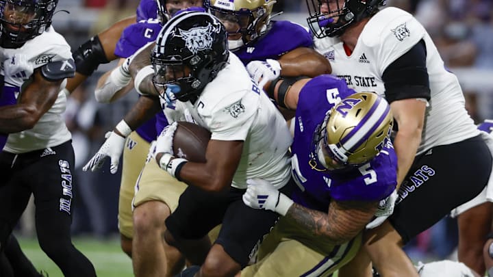 Aug 31, 2024; Seattle, Washington, USA; Washington Huskies edge Zach Durfee (5) tackles Weber State Wildcats running back Damon Bankston (1)during the second quarter at Alaska Airlines Field at Husky Stadium. Mandatory Credit: Joe Nicholson-Imagn Images