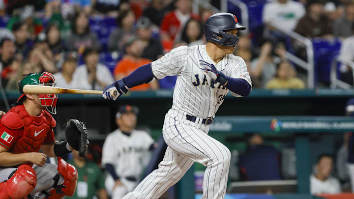 Mar 20, 2023; Miami, Florida, USA; Japan left fielder Masataka Yoshida (34) hits a single during the second inning against Mexico at LoanDepot Park. Mandatory Credit: Sam Navarro-Imagn Images