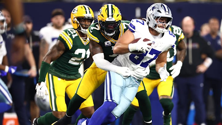 Green Bay Packers linebacker Quay Walker tackles Dallas Cowboys tight end Jake Ferguson.