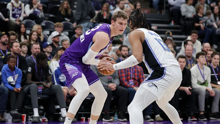 Feb 1, 2025; Salt Lake City, Utah, USA;  Utah Jazz forward Lauri Markkanen (23) controls the ball against Orlando Magic guard Jett Howard (13) during the second half at Delta Center. Mandatory Credit: Chris Nicoll-Imagn Images