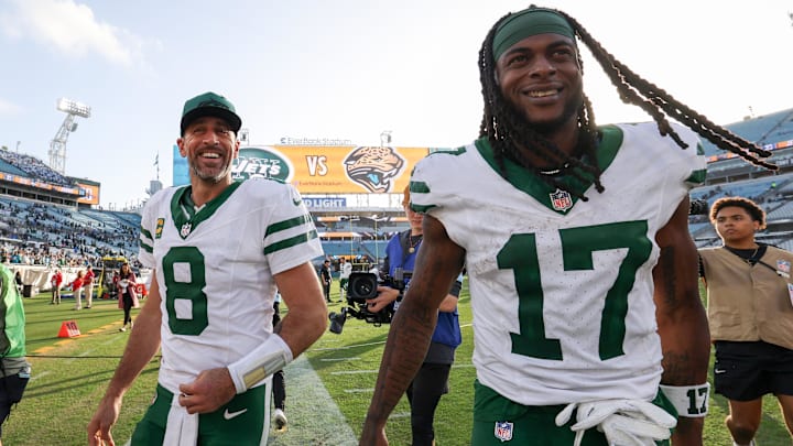 Dec 15, 2024; Jacksonville, Florida, USA; New York Jets quarterback Aaron Rodgers (8) and wide receiver Davante Adams (17) celebrates after beating the Jacksonville Jaguars at EverBank Stadium. 