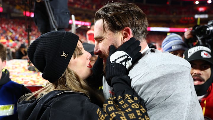 Jan 26, 2025; Kansas City, MO, USA; Recording artist Taylor Swift  and Kansas City Chiefs tight end Travis Kelce (87) react after the AFC Championship game against the Buffalo Bills at GEHA Field at Arrowhead Stadium. 