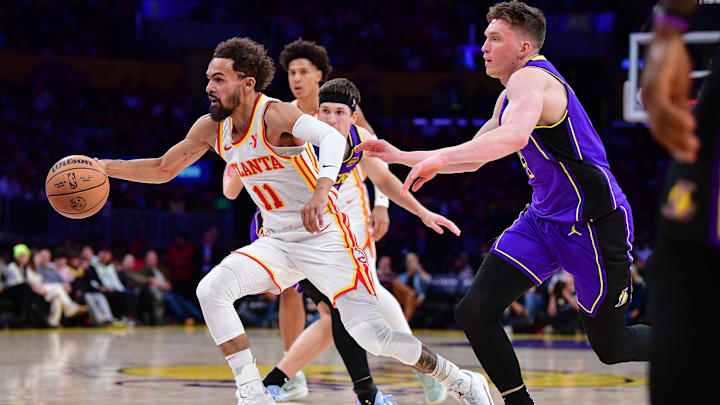 Jan 3, 2025; Los Angeles, California, USA; Atlanta Hawks guard Trae Young (11) moves to the basket ahead of Los Angeles Lakers guard Dalton Knecht (4) during the first half at Crypto.com Arena. Mandatory Credit: Gary A. Vasquez-Imagn Images