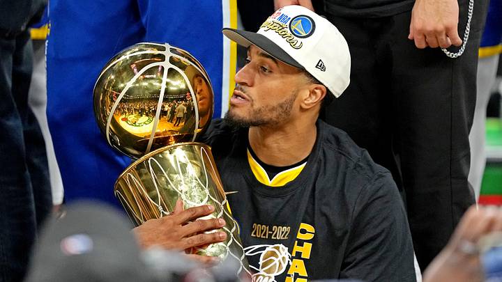 Jun 16, 2022; Boston, Massachusetts, USA; Golden State Warriors guard Gary Payton II (0) holds the the Larry O'Brien Championship Trophy after the Golden State Warriors beat the Boston Celtics in game six of the 2022 NBA Finals to win the NBA Championship at TD Garden. Mandatory Credit: Kyle Terada-Imagn Images
