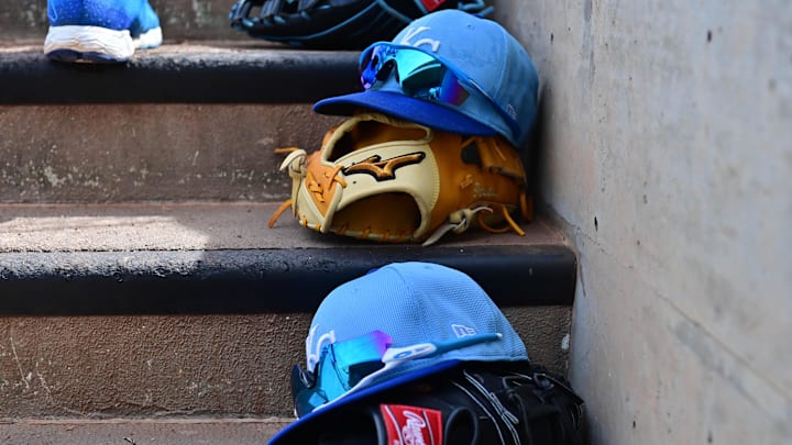 Mar 12, 2024; Salt River Pima-Maricopa, Arizona, USA;  General view of Kansas City Royals hats and gloves in the first inning against the Colorado Rockies during a spring training game at Salt River Fields at Talking Stick. Mandatory Credit: Matt Kartozian-Imagn Images