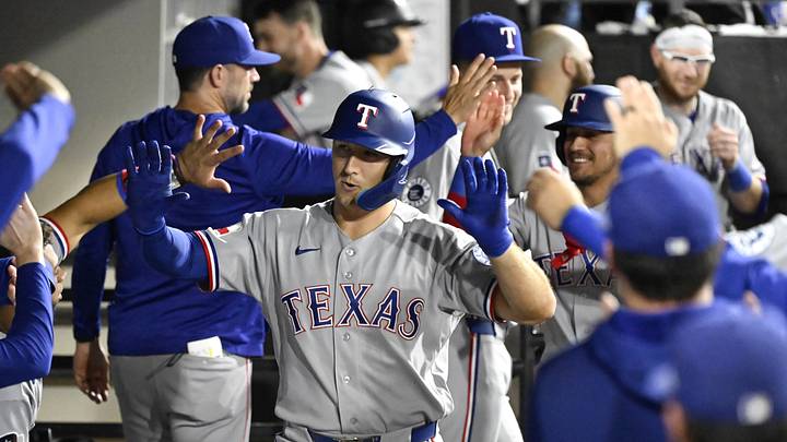 Aug 24, 2026; Chicago, Illinois, USA;  Texas Rangers left fielder Wyatt Langford (36) celebrates in the dugout after hitting a two run home run during the ninth inning against the Chicago White Sox at Rate Field.  Mandatory Credit: Matt Marton-Imagn Images