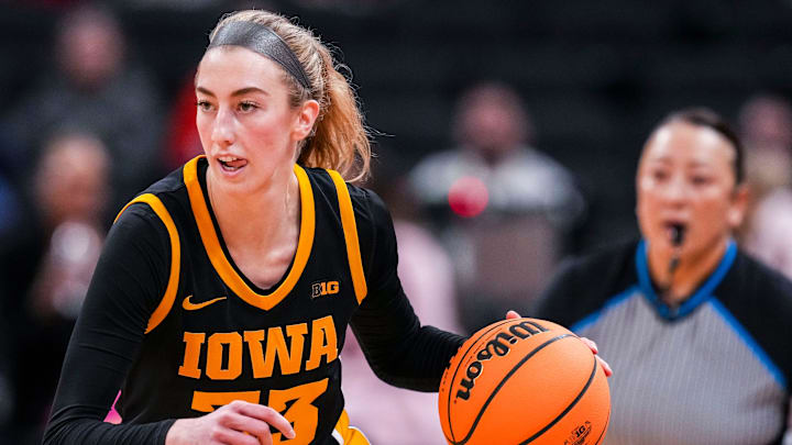 Iowa Hawkeyes guard Lucy Olsen (33) brings the ball up the court Friday, March 7, 2025, in a quarterfinals game at the 2025 TIAA Big Ten Women's Basketball Tournament between the Iowa Hawkeyes and the Ohio State Buckeyes at Gainbridge Fieldhouse in Indianapolis.