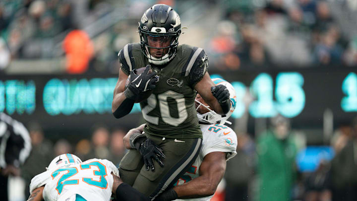 New York Jets running back Breece Hall (20) runs the ball before being tackled by Miami Dolphins linebacker Tyrel Dodson (25) during a week 14 football game between the New York Jets and Miami Dolphins at MetLife Stadium on Sunday, Dec. 7, 2025.