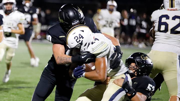 Gateway's Jakson Smith, left, and Julius Clark, right, haul down Kiski Area's Ashton Taylor during a 31-10 Gators' win Week 1 at Antimarino Stadium in Monroeville.