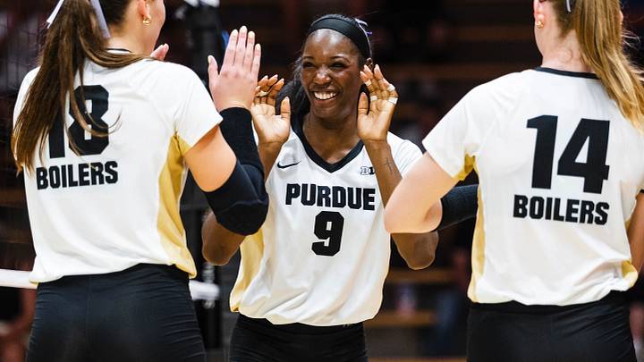 Purdue middle blocker Dior Charles celebrates with her teammates.