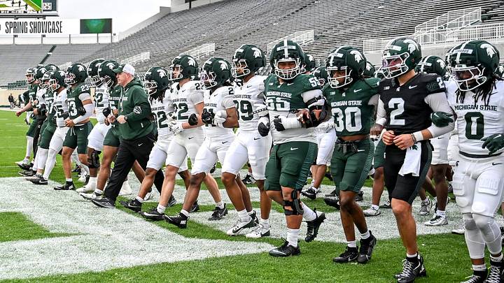 Michigan State's head coach Pat Fitzgerald and the team walk across the end zone during the football Spring Showcase on Saturday, April 18, 2026, at Spartan Stadium in East Lansing. Michigan State's head coach Pat Fitzgerald and the team walk across the end zone during the football Spring Showcase on Saturday, April 18, 2026, at Spartan Stadium in East Lansing.
