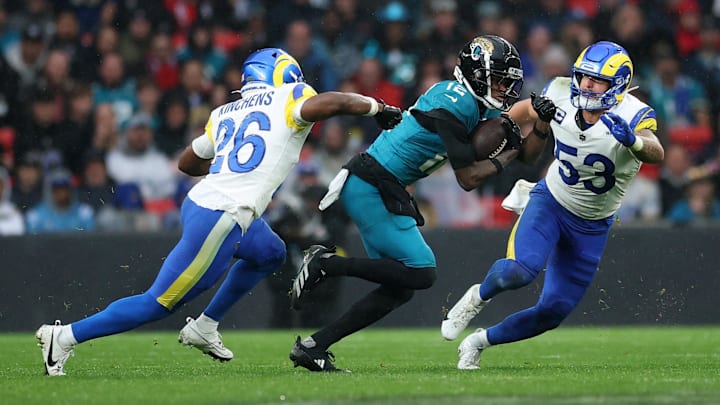Oct 19, 2025; London, United Kingdom; Jacksonville Jaguars wide receiver Travis Hunter (12) runs with the ball against Los Angeles Rams safety Kamren Kinchens (26) and linebacker Nate Landman (53) during the second half during a NFL International Series game at Wembley Stadium. Mandatory Credit: Andrew Boyers-Reuters via Imagn Images Oct 19, 2025; London, United Kingdom; Jacksonville Jaguars wide receiver Travis Hunter (12) runs with the ball against Los Angeles Rams safety Kamren Kinchens (26) and linebacker Nate Landman (53) during the second half during a NFL International Series game at Wembley Stadium. Mandatory Credit: Andrew Boyers-Reuters via Imagn Images