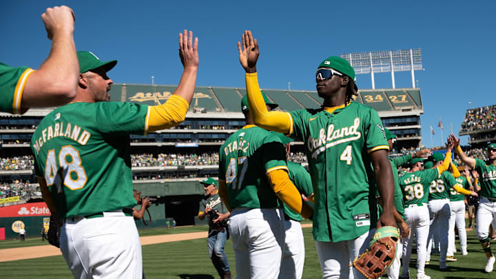 Sep 26, 2024; Oakland, California, USA; Oakland Athletics pitcher T.J. McFarland (48) high fives outfielder Lawrence Butler (4) after defeating the Texas Rangers at Oakland-Alameda County Coliseum. Mandatory Credit: Ed Szczepanski-Imagn Images
