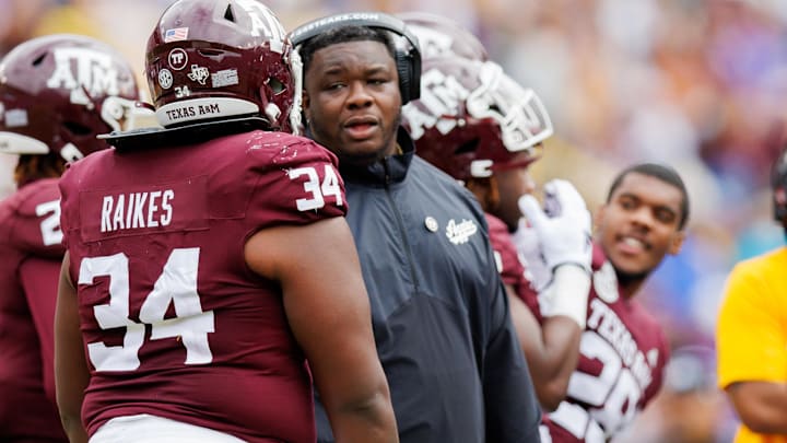 Nov 25, 2023; Baton Rouge, Louisiana, USA; Texas A&M Aggies interim head coach Elijah Robinson talks to defensive lineman Isaiah Raikes (34) on a time out against the LSU Tigers during the second half at Tiger Stadium. Mandatory Credit: Stephen Lew-Imagn Images Nov 25, 2023; Baton Rouge, Louisiana, USA; Texas A&M Aggies interim head coach Elijah Robinson talks to defensive lineman Isaiah Raikes (34) on a time out against the LSU Tigers during the second half at Tiger Stadium. Mandatory Credit: Stephen Lew-Imagn Images