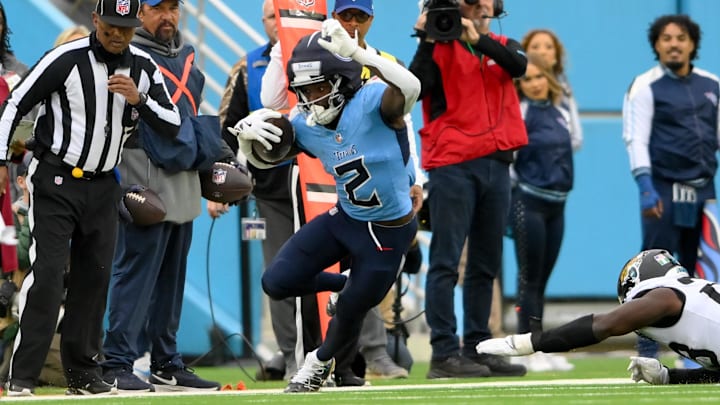 Dec 8, 2024; Nashville, Tennessee, USA;  Tennessee Titans running back Tyjae Spears (2) tiptoes down the sidelines against the Jacksonville Jaguars during the first half at Nissan Stadium. Mandatory Credit: Steve Roberts-Imagn Images