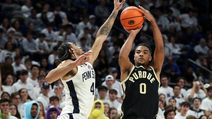 Dec 5, 2024; University Park, Pennsylvania, USA; Purdue Boilermakers guard CJ Cox (0) shoots the ball as Penn State Nittany Lions guard Freddie Dilione V (4) defends during the second half at Bryce Jordan Center. Penn State defeated Purdue 81-70. Mandatory Credit: Matthew O'Haren-Imagn Images