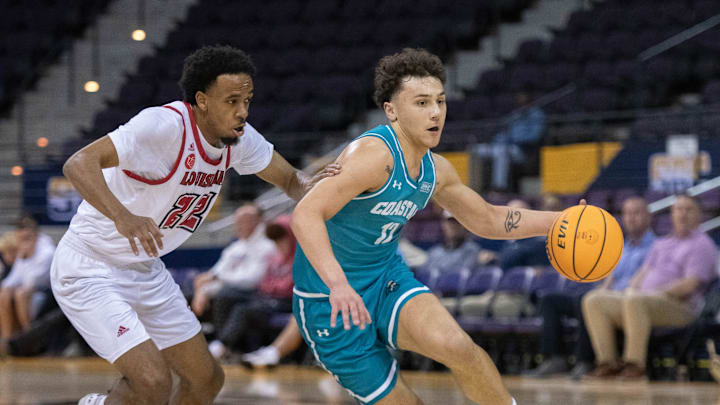 Jacob Meyer (12) brings the ball up court during the Coastal Carolina University vs University of