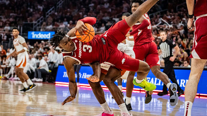 Arkansas Razorbacks forward Adou Thiero (3) tumbles over Texas Longhorns forward Ze'Rik Onyema (21) after catching the rebound in the first half as the Longhorns take on the Razorbacks at the Moody Center, Feb. 5, 2025.
