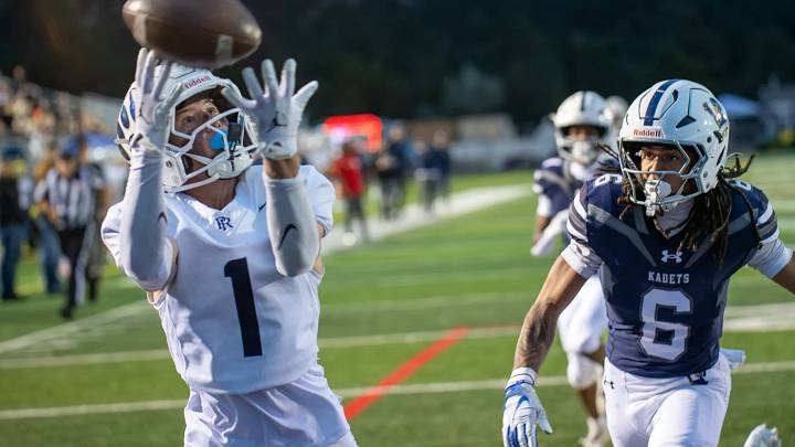 Palmer Ridge player Zak Crisler (left) hauls in a pass during a recent ballgame. Palmer Ridge player Zak Crisler (left) hauls in a pass during a recent ballgame.