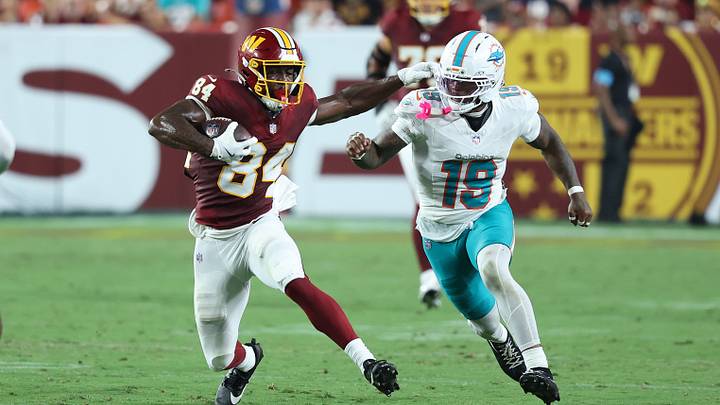 Washington Commanders wide receiver Jacoby Jones (84) runs with the ball as Miami Dolphins linebacker Kyle Louis (19) defends during the second half at Northwest Stadium. Washington Commanders wide receiver Jacoby Jones (84) runs with the ball as Miami Dolphins linebacker Kyle Louis (19) defends during the second half at Northwest Stadium.