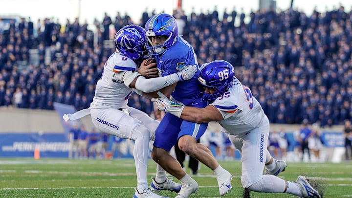 Sep 20, 2025; Colorado Springs, Colorado, USA; Air Force Falcons quarterback Liam Szarka (9) runs the ball against Boise State Broncos defensive back Jeremiah Earby (6) and defensive lineman Max Stege (95) in the second quarter at Falcon Stadium. 