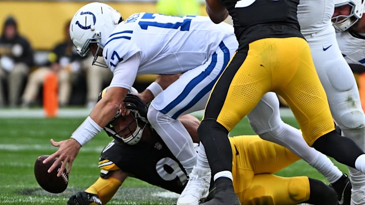 Nov 2, 2025; Pittsburgh, Pennsylvania, USA; Indianapolis Colts quarterback Daniel Jones (17) and Pittsburgh Steelers place kicker Chris Boswell (9) both go for the ball during the first half at Acrisure Stadium. Mandatory Credit: Barry Reeger-Imagn Images
