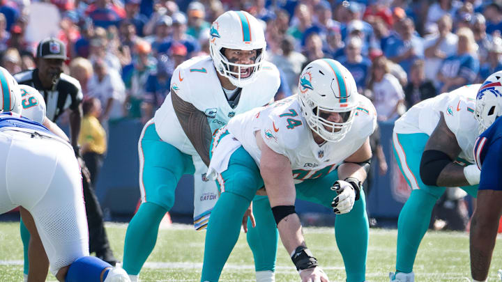 Oct 1, 2023; Orchard Park, New York, USA; Miami Dolphins quarterback Tua Tagovailoa (1) and center Liam Eichenberg (74) at the line of scrimmage in the second quarter against the Buffalo Bills  at Highmark Stadium. Mandatory Credit: Mark Konezny-USA TODAY Sports
