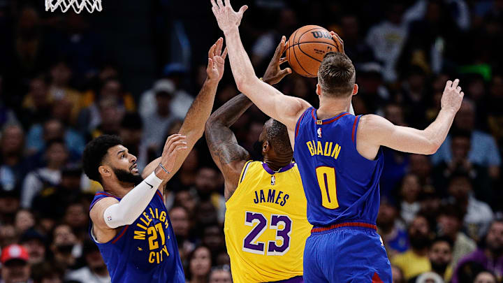 Oct 24, 2023; Denver, Colorado, USA; Los Angeles Lakers forward LeBron James (23) drives to the net against Denver Nuggets guard Jamal Murray (27) and guard Christian Braun (0) in the second quarter at Ball Arena. Mandatory Credit: Isaiah J. Downing-Imagn Images Oct 24, 2023; Denver, Colorado, USA; Los Angeles Lakers forward LeBron James (23) drives to the net against Denver Nuggets guard Jamal Murray (27) and guard Christian Braun (0) in the second quarter at Ball Arena. Mandatory Credit: Isaiah J. Downing-Imagn Images