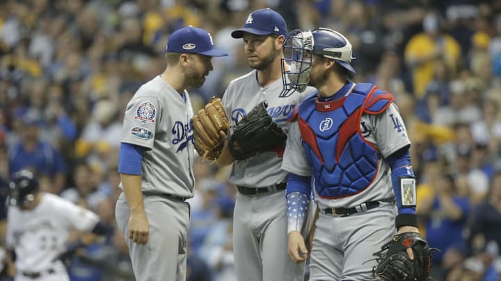 Oct 19, 2018; Milwaukee, WI, USA; Los Angeles Dodgers second baseman Brain Dozier (6) and starting pitcher Rich Hill (44) and catcher Yasmani Grandal (9) meet at the mound during the eighth inning against the Milwaukee Brewers in game six of the 2018 NLCS playoff baseball series at Miller Park. Mandatory Credit: Jon Durr-Imagn Images Oct 19, 2018; Milwaukee, WI, USA; Los Angeles Dodgers second baseman Brain Dozier (6) and starting pitcher Rich Hill (44) and catcher Yasmani Grandal (9) meet at the mound during the eighth inning against the Milwaukee Brewers in game six of the 2018 NLCS playoff baseball series at Miller Park. Mandatory Credit: Jon Durr-Imagn Images