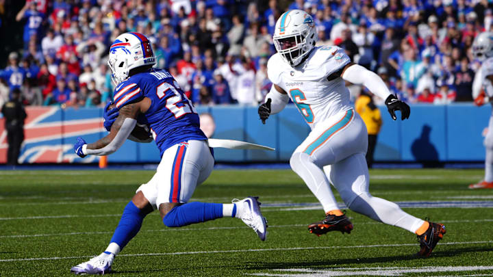 Buffalo Bills running back Ray Davis (22) runs with the ball against Miami Dolphins linebacker Anthony Walker Jr. (6) during the first half at Highmark Stadium.