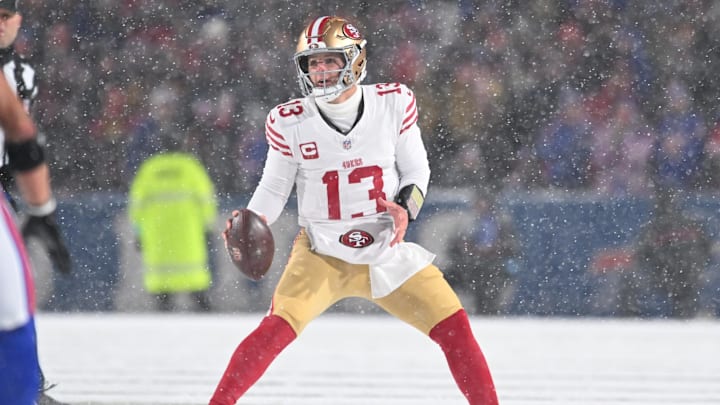 Dec 1, 2024; Orchard Park, New York, USA; San Francisco 49ers quarterback Brock Purdy (13) moves out of the pocket to throw a pass against the Buffalo Bills in the second quarter at Highmark Stadium. Mandatory Credit: Mark Konezny-Imagn Images
