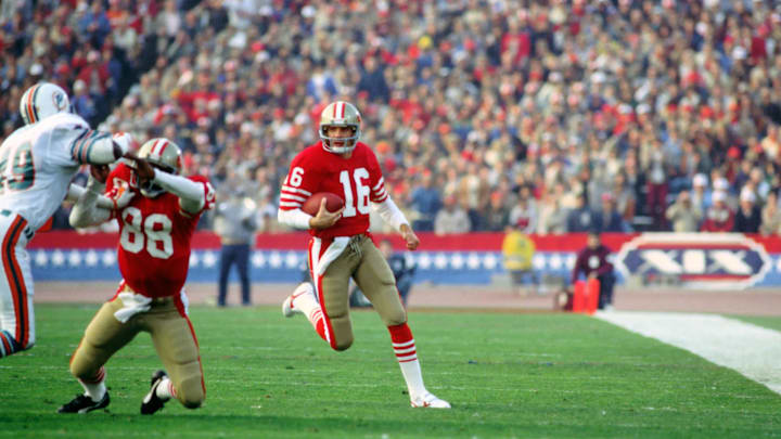 Jan 20, 1985, Palo Alto, CA, USA; FILE PHOTO; San Francisco 49ers quarterback carries the ball against the Miami Dolphins during Super Bowl XIX at Stanford Stadium. The 49ers defeated the Dolphins 38-16. Mandatory Credit: Tony Tomsic-Imagn Images