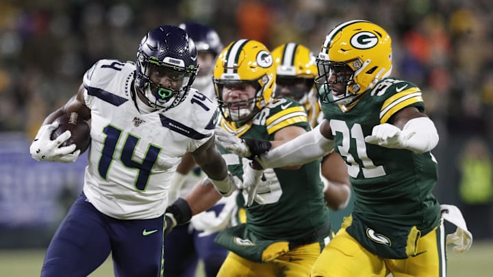 Jan 12, 2020; Green Bay, WI, USA; Seattle Seahawks wide receiver D.K. Metcalf (14) tries to get away from Green Bay Packers strong safety Adrian Amos (31)  in the third quarter of a NFC Divisional Round playoff football game at Lambeau Field. Mandatory Credit: Jeff Hanisch-Imagn Images