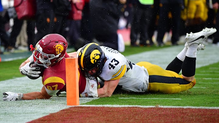 Nov 15, 2025; Los Angeles, California, USA; Southern California Trojans tight end Lake McRee (87) is stopped short of the goal line by Iowa Hawkeyes linebacker Karson Sharar (43) during the second half at the Los Angeles Memorial Coliseum. Mandatory Credit: Gary A. Vasquez-Imagn Images