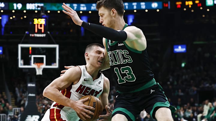 Dec 2, 2024; Boston, Massachusetts, USA; Miami Heat guard Tyler Herro (14) runs into Boston Celtics forward Drew Peterson (13) during the first quarter at TD Garden. Mandatory Credit: Winslow Townson-Imagn Images