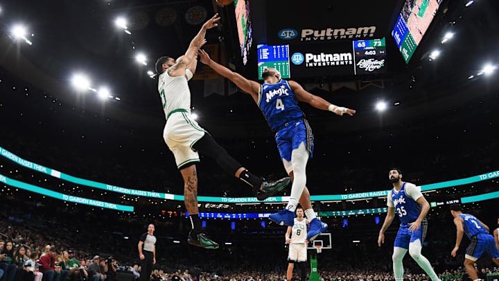 Boston Celtics forward Jayson Tatum (0) shoots the ball over Orlando Magic guard Jalen Suggs (4) during the second half at TD Garden.