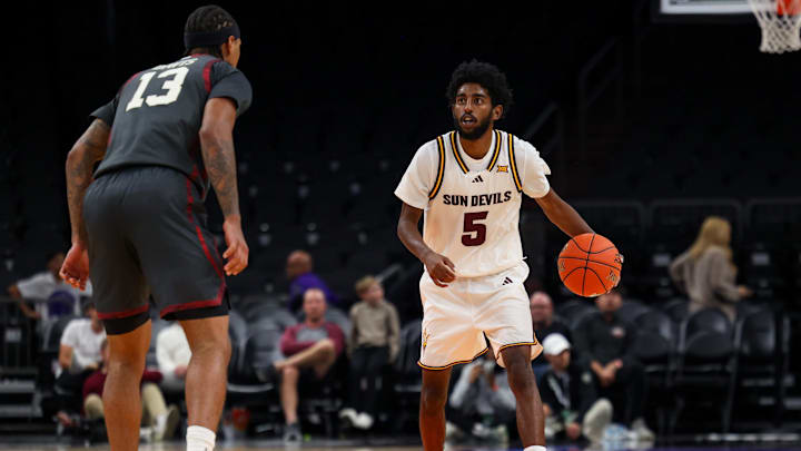 Dec 6, 2025; Phoenix, Arizona, USA; Arizona State University Sun Devils guard Moe Odum (5) dribbles down court against Oklahoma University Sooners forward Tae Davis (13) in the second half at PHX Arena. Mandatory Credit: Anna Carrington-Imagn Images Dec 6, 2025; Phoenix, Arizona, USA; Arizona State University Sun Devils guard Moe Odum (5) dribbles down court against Oklahoma University Sooners forward Tae Davis (13) in the second half at PHX Arena. Mandatory Credit: Anna Carrington-Imagn Images