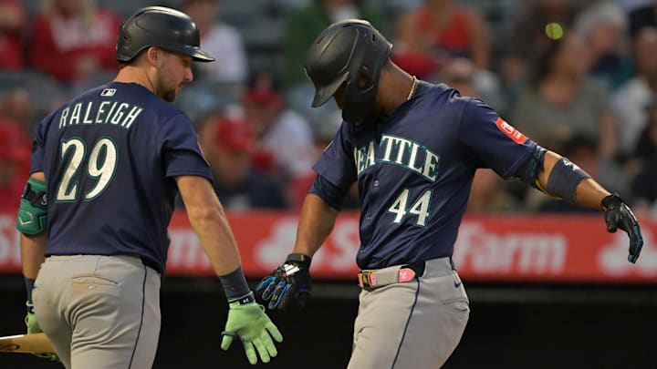Jul 24, 2025; Anaheim, California, USA;  Seattle Mariners center fielder Julio Rodriguez (44) is congratulated by catcher Cal Raleigh (29) after hitting a solo home run in the fifth inning against the Los Angeles Angels at Angel Stadium. Mandatory Credit: Jayne Kamin-Oncea-Imagn Images