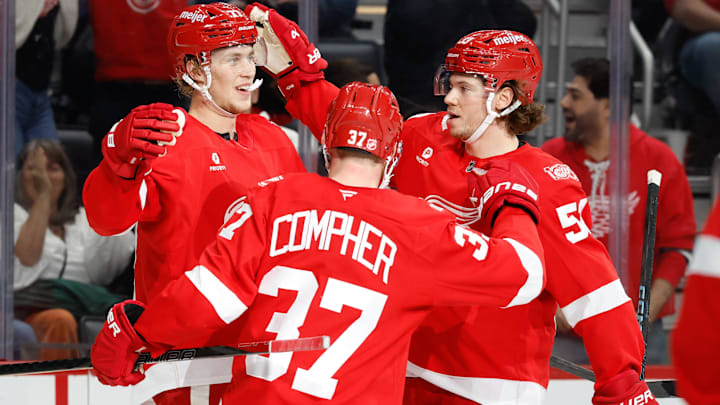 Oct 25, 2025; Detroit, Michigan, USA;  Detroit Red Wings defenseman Simon Edvinsson (77) receives congratulations from teammates after scoring in the third period against the St. Louis Blues at Little Caesars Arena. Mandatory Credit: Rick Osentoski-Imagn Images