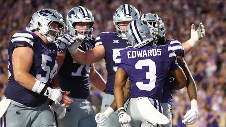 Aug 31, 2024; Manhattan, Kansas, USA; Kansas State Wildcats running back Dylan Edwards (3) is congratulated by teammates after scoring a touchdown in the third quarter against the Tennessee-Martin Skyhawks at Bill Snyder Family Football Stadium. Mandatory Credit: Scott Sewell-Imagn Images