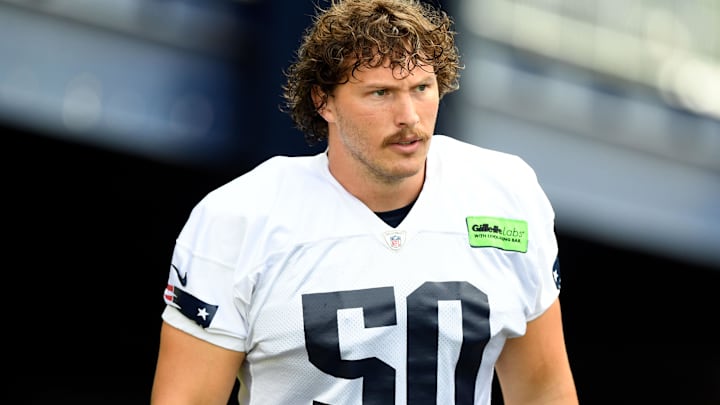New England Patriots offensive lineman Cole Strange (50) walks onto the field before training camp at Gillette Stadium.