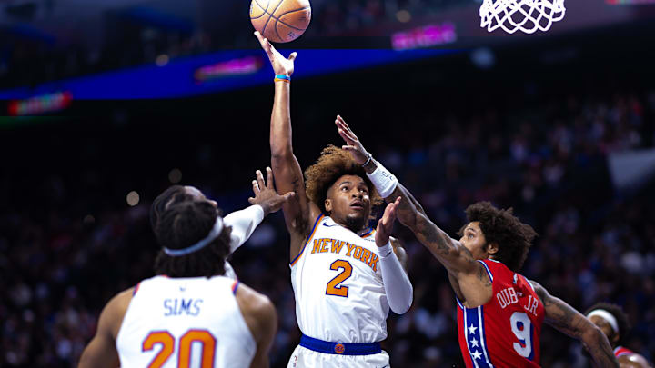 Nov 12, 2024; Philadelphia, Pennsylvania, USA; New York Knicks guard Miles McBride (2) shoots the ball against Philadelphia 76ers guard Kelly Oubre Jr. (9) during the second quarter at Wells Fargo Center. Mandatory Credit: Bill Streicher-Imagn Images